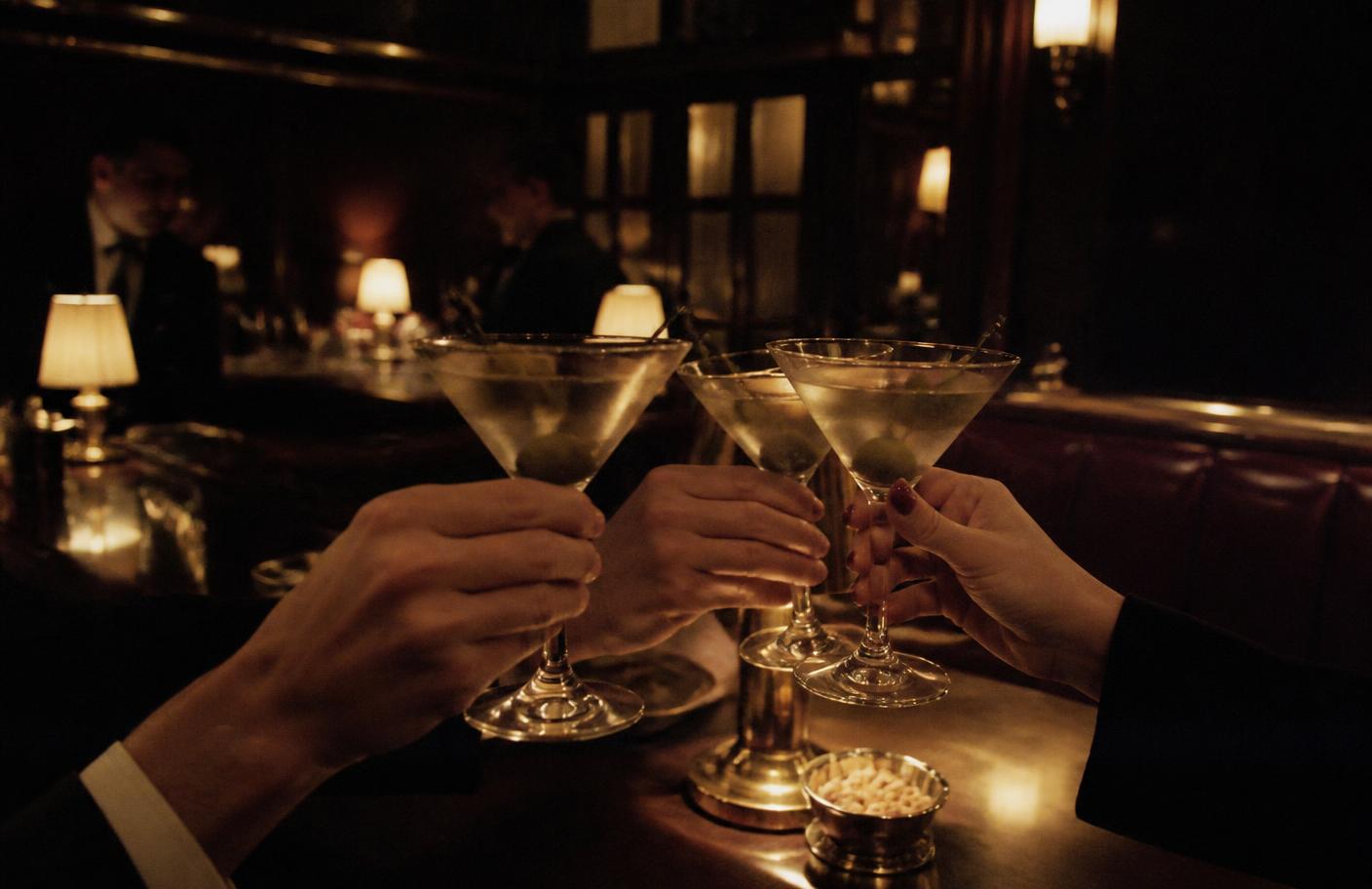 Cocktails on a bar in low amber light